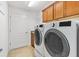 Laundry room with washer, dryer, tile floor and cabinets at 3732 Barrel Loop, The Villages, FL 32163