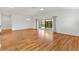 Bright and airy living room with wood floors and sliding glass doors to the lanai at 3732 Barrel Loop, The Villages, FL 32163