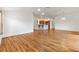 Spacious living room featuring wood flooring with a view into the open-concept kitchen at 3732 Barrel Loop, The Villages, FL 32163