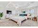 Main bedroom with virtually staged furnishings and large TV at 3732 Barrel Loop, The Villages, FL 32163