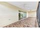 Screened porch with sliding glass doors and brick tile flooring at 3732 Barrel Loop, The Villages, FL 32163