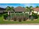 Professionally landscaped backyard featuring decorative rock, flowering plants and manicured shrubs at 1338 Neuport Path, The Villages, FL 32163