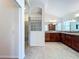 Spacious bathroom with a walk-in shower, dual vanities, and tile flooring at 1338 Neuport Path, The Villages, FL 32163
