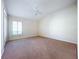 Bedroom with a large window, neutral walls, and a ceiling fan at 1338 Neuport Path, The Villages, FL 32163