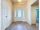 Bright entryway with tile floors, a decorative front door with sidelights, and a glimpse into the home's interior at 1338 Neuport Path, The Villages, FL 32163