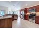 Modern kitchen with stainless steel appliances, granite countertops, and abundant cabinet space at 1338 Neuport Path, The Villages, FL 32163