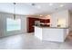 Open-concept kitchen with breakfast bar, stainless appliances, and tile floors at 1338 Neuport Path, The Villages, FL 32163