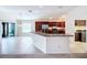 Open-concept kitchen with stainless steel appliances, granite countertops, and a seamless flow to the dining area at 1338 Neuport Path, The Villages, FL 32163