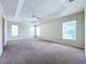 Spacious primary bedroom featuring tray ceilings, neutral paint, and multiple windows for lots of light at 1338 Neuport Path, The Villages, FL 32163