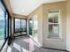 Sunroom with tiled floor, large windows providing natural light and view to exterior landscaping at 1338 Neuport Path, The Villages, FL 32163