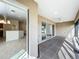 Patio with tiled floor, ceiling fan, multiple sliding glass doors, and views to the kitchen at 1338 Neuport Path, The Villages, FL 32163