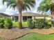 Well-maintained backyard with a spacious screened lanai, decorative rock, and mature landscaping at 1338 Neuport Path, The Villages, FL 32163