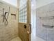 Walk-in shower with grab bars, glass block, and hand-held shower head offers safety and accessibility at 1338 Neuport Path, The Villages, FL 32163
