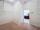 Spacious walk-in closet with built in shelving and carpeted floors and bathroom in view at 1338 Neuport Path, The Villages, FL 32163
