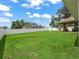 Spacious backyard featuring lush lawn, white fencing, and recreational play equipment at 8830 Se 161St Pl, Summerfield, FL 34491