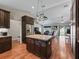 Open concept living room and kitchen with granite island and stainless steel refrigerator at 8830 Se 161St Pl, Summerfield, FL 34491