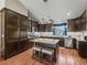 Gourmet kitchen with granite countertops, stainless steel appliances, and kitchen island at 8830 Se 161St Pl, Summerfield, FL 34491