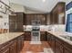 Gourmet kitchen with granite countertops, stainless steel appliances, and ample cabinet storage at 8830 Se 161St Pl, Summerfield, FL 34491