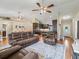 Spacious living room with wood floors, a ceiling fan, and open access to the dining and kitchen areas at 8830 Se 161St Pl, Summerfield, FL 34491