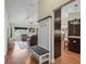 Open-concept living area featuring wood flooring, a coat rack bench, and an entryway to the kitchen at 8830 Se 161St Pl, Summerfield, FL 34491