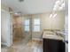 Modern main bathroom featuring a glass enclosed shower and double sink vanity at 8830 Se 161St Pl, Summerfield, FL 34491