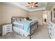 Bright main bedroom with large window, ceiling fan, and ensuite bathroom at 8830 Se 161St Pl, Summerfield, FL 34491