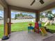Covered patio overlooking a spacious backyard perfect for entertaining at 8830 Se 161St Pl, Summerfield, FL 34491