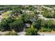 Aerial view showcasing a home nestled among mature trees in a tranquil residential neighborhood at 8566 Se 156Th Pl, Summerfield, FL 34491