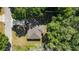 Aerial view of a single-story home with mature landscaping, surrounded by lush green trees at 8566 Se 156Th Pl, Summerfield, FL 34491