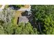 Aerial view of a single Gathering home featuring a gray roof with mature trees surrounding the property at 8566 Se 156Th Pl, Summerfield, FL 34491