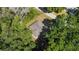 Aerial view showcasing a home nestled among mature trees and neighboring street at 8566 Se 156Th Pl, Summerfield, FL 34491