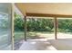 Back porch with concrete flooring overlooking a large, grassy yard at 8566 Se 156Th Pl, Summerfield, FL 34491