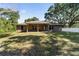 A large backyard featuring a covered patio, and abundant green space at 8566 Se 156Th Pl, Summerfield, FL 34491