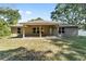 The backyard features a covered patio and a well-maintained lawn at 8566 Se 156Th Pl, Summerfield, FL 34491