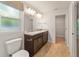 Bright bathroom features a double sink vanity with granite countertops, modern lighting, and an adjoining closet at 8566 Se 156Th Pl, Summerfield, FL 34491