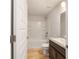Bathroom featuring a tub and shower combination, white tile, and dark wood vanity at 8566 Se 156Th Pl, Summerfield, FL 34491