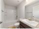 The bathroom features a vanity, shower, and tub combination for a relaxing bathing experience at 8566 Se 156Th Pl, Summerfield, FL 34491