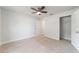 This bright bedroom features neutral walls, carpet, a closet, and a ceiling fan at 8566 Se 156Th Pl, Summerfield, FL 34491