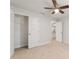 Bedroom includes a ceiling fan, plush carpet, access to a closet, and additional rooms at 8566 Se 156Th Pl, Summerfield, FL 34491