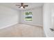 This bedroom features neutral walls, carpet, and a ceiling fan for optimal comfort at 8566 Se 156Th Pl, Summerfield, FL 34491