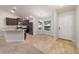 Bright dining area with wood-style flooring adjacent to the kitchen at 8566 Se 156Th Pl, Summerfield, FL 34491
