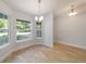 Bright dining area with wood-look floors and multiple windows offering lots of natural light at 8566 Se 156Th Pl, Summerfield, FL 34491