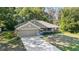 Well-maintained single story home with a lush green lawn and mature trees, featuring a cozy covered front porch at 8566 Se 156Th Pl, Summerfield, FL 34491