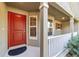Close-up of the front door showing the covered porch with a storm door at 8566 Se 156Th Pl, Summerfield, FL 34491