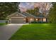 Well-maintained single Gathering home featuring a manicured front lawn, 2-car garage, and professional landscaping at 8566 Se 156Th Pl, Summerfield, FL 34491