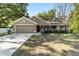 Single Gathering home featuring a manicured front lawn, 2-car garage, and mature landscaping at 8566 Se 156Th Pl, Summerfield, FL 34491