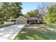 Charming single Gathering home with a well manicured front lawn, a two-car garage, and sidewalk at 8566 Se 156Th Pl, Summerfield, FL 34491