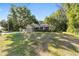 Single Gathering home with a well-manicured front lawn, a 2-car garage, sidewalk, and mature shade trees at 8566 Se 156Th Pl, Summerfield, FL 34491