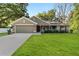 Charming single-story home with lush green lawn and well-maintained landscaping, featuring a two-car garage at 8566 Se 156Th Pl, Summerfield, FL 34491