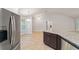 Bright kitchen area with stainless steel fridge and open view into a dining room at 8566 Se 156Th Pl, Summerfield, FL 34491